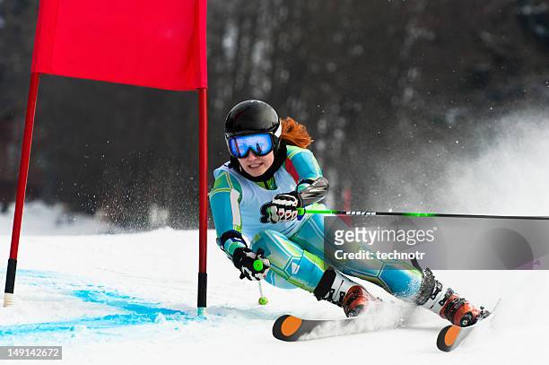 young attractive woman at giant slalom race - alpineskiën stockfoto's en -beelden