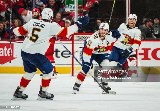 Matthew Tkachuk of the Florida Panthers celebrates with teammates after scoring the game-winning goal during the fourth overtime to defeat the...