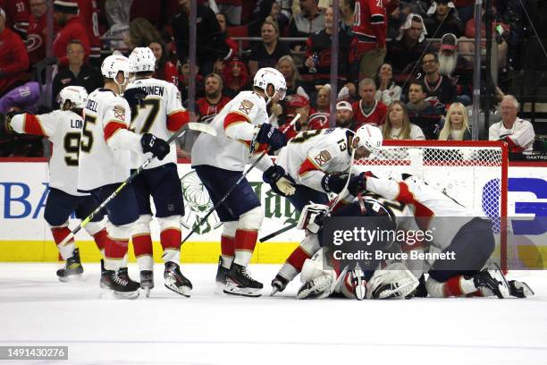 Sergei Bobrovsky of the Florida Panthers celebrates with his teammates after defeating the Carolina Hurricanes in fourth overtime in Game One of the...