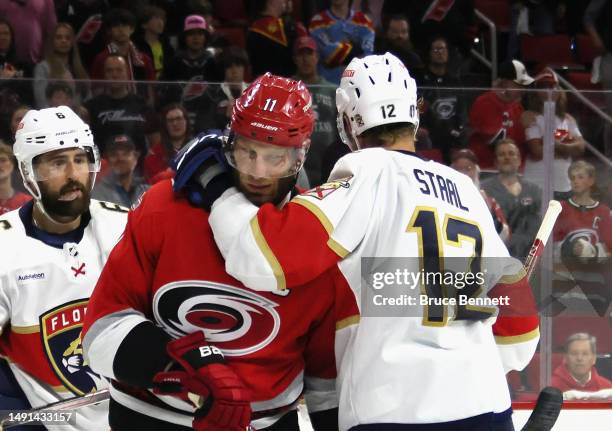Eric Staal of the Florida Panthers hangs on to his brother Jordan Staal of the Carolina Hurricanes in Game One of the Eastern Conference Final of the...