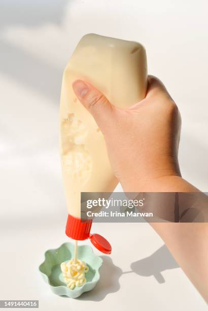 pouring mayonaise from a squeeze bottle - cream tube stock pictures, royalty-free photos & images