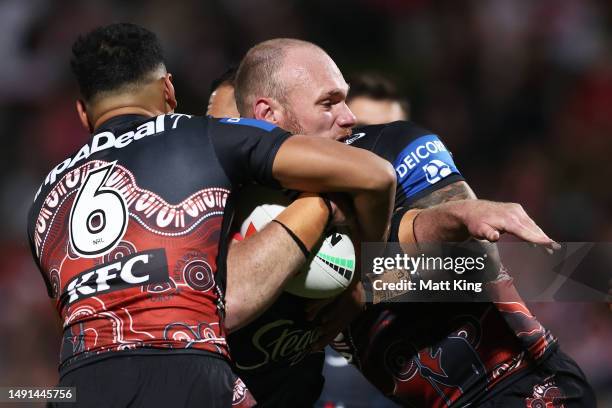 Matthew Lodge of the Roosters is tackled during the round 12 NRL match between St George Illawarra Dragons and Sydney Roosters at Netstrata Jubilee...