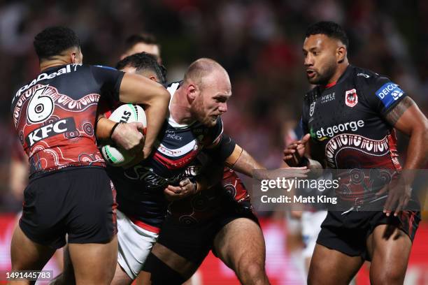 Matthew Lodge of the Roosters is tackled during the round 12 NRL match between St George Illawarra Dragons and Sydney Roosters at Netstrata Jubilee...