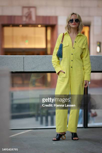Violet Grace Atkinson wearing yellow jumpsuit and Celine bag at Afterpay Australian Fashion Week 2023 at Carriageworks on May 19, 2023 in Sydney,...
