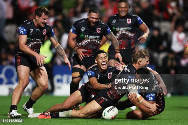 Mathew Feagai of the Dragons celebrates with team mates after scoring the match winning try during the round 12 NRL match between St George Illawarra...