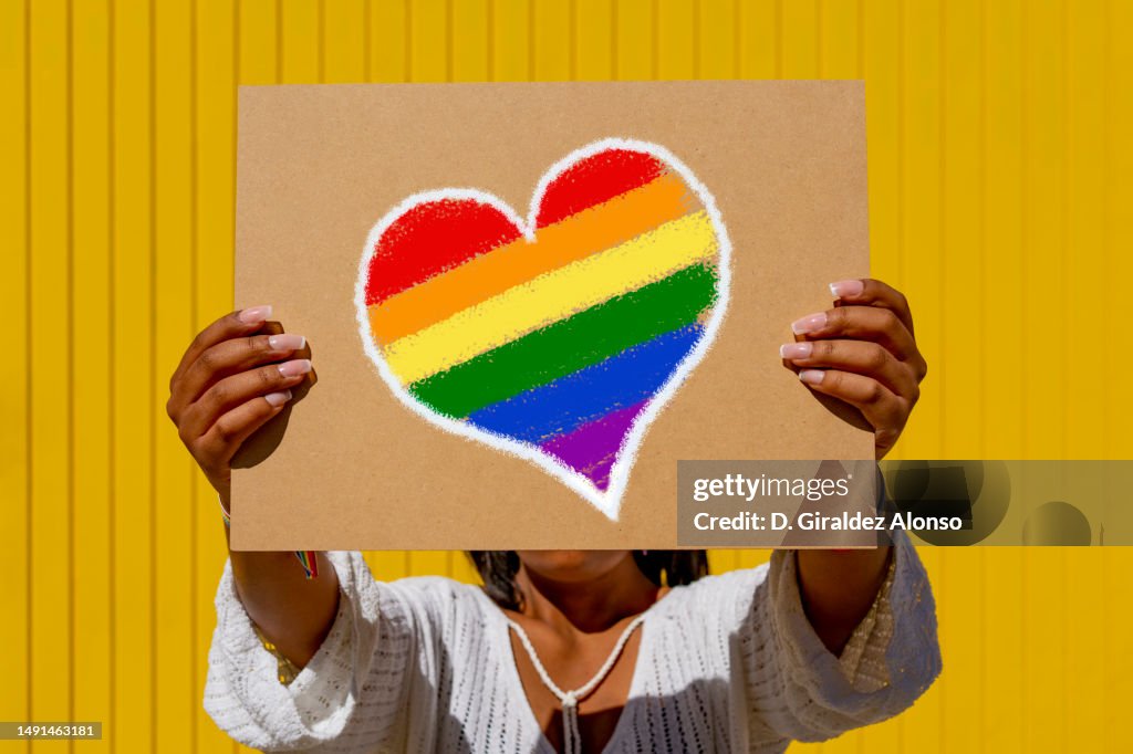 Ainbow flag heart placard sign, symbol of LGBT