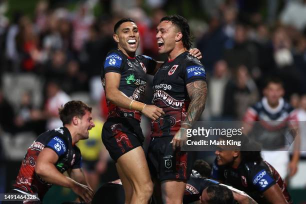 Tyrell Sloan and Jaydn Su'a of the Dragons celebrate victory with team mates during the round 12 NRL match between St George Illawarra Dragons and...