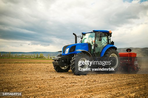 farmer planting seeds with tractor and seeder