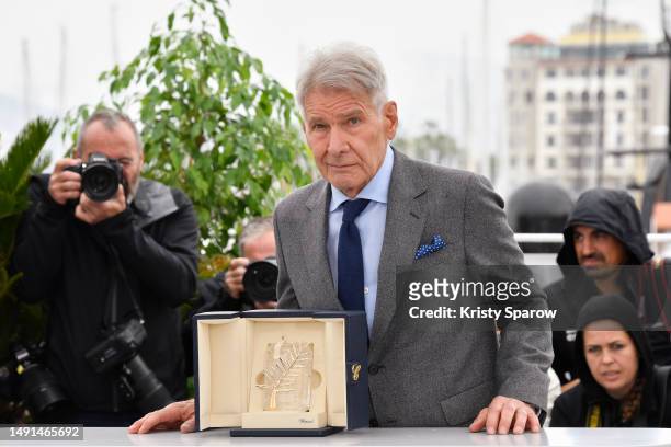 Harrison Ford poses with the honorary Palme D'Or he received, at the "Indiana Jones And The Dial Of Destiny" photocall at the 76th annual Cannes film...