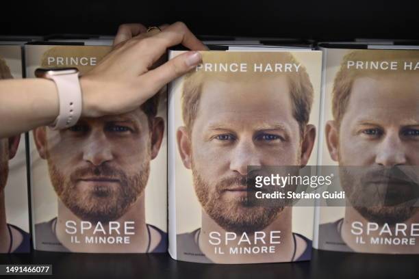 Hands holds the Prince Harry book Spare during the Turin Book Fair 2023 on May 19, 2023 in Turin, Italy. The Turin International Book Fair is the...
