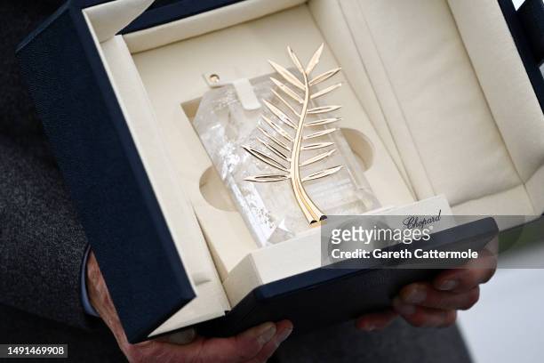 Harrison Ford shows the honorary Palme D'Or he received, at the "Indiana Jones And The Dial Of Destiny" photocall at the 76th annual Cannes film...