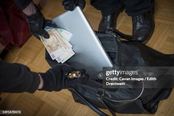 burglars stealing laptop, fifty euro banknotes and jewelry - jewelry robbery stock pictures, royalty-free photos & images