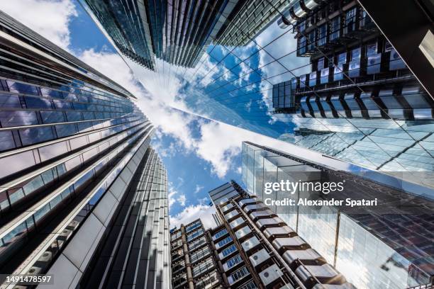 low angle view of modern futuristic glass skyscrapers with reflections, london, uk - banking stock pictures, royalty-free photos & images