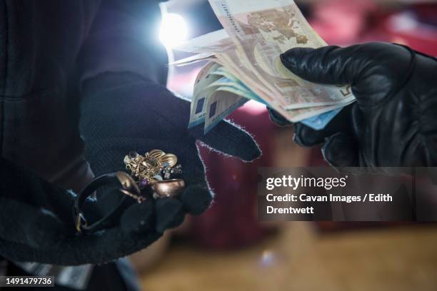 burglars stealing jewelry and euro banknotes - jewelry robbery stock pictures, royalty-free photos & images