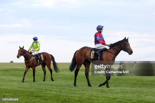 Jockey James Doyle riding Power of Gold and Jockey Joe Fanning riding Muir Wood at Newmarket Racecourse on May 18, 2023 in Newmarket, England.