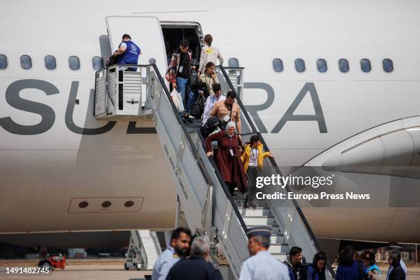 Several people with children descend the stairs of the plane coming from Syria, upon arrival at the Torrejon de Ardoz air base, on 19 May, 2023 in...