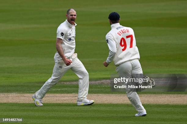 Bowler James Harris of Glamorgan celebrates with team mate Eddie Byrom after dismissing Steve Smith of Sussex during the LV= Insurance County...