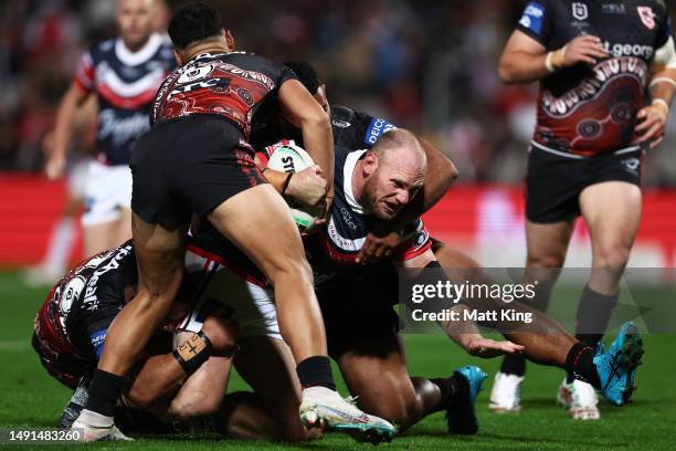 Matthew Lodge of the Roosters is tackled during the round 12 NRL match between St George Illawarra Dragons and Sydney Roosters at Netstrata Jubilee...