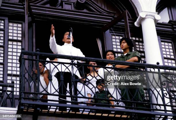 Philippine President Ferdinand Marcos gives the final speech of his presidency to supporters from the balcony of Malacanang Palace following his...