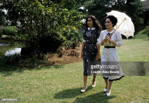 Dewi Sukarno strolls the gardens of her former home, Wisma Yaso, with daughter Kartika Soekarno, Jakarta, 2nd August 1982.