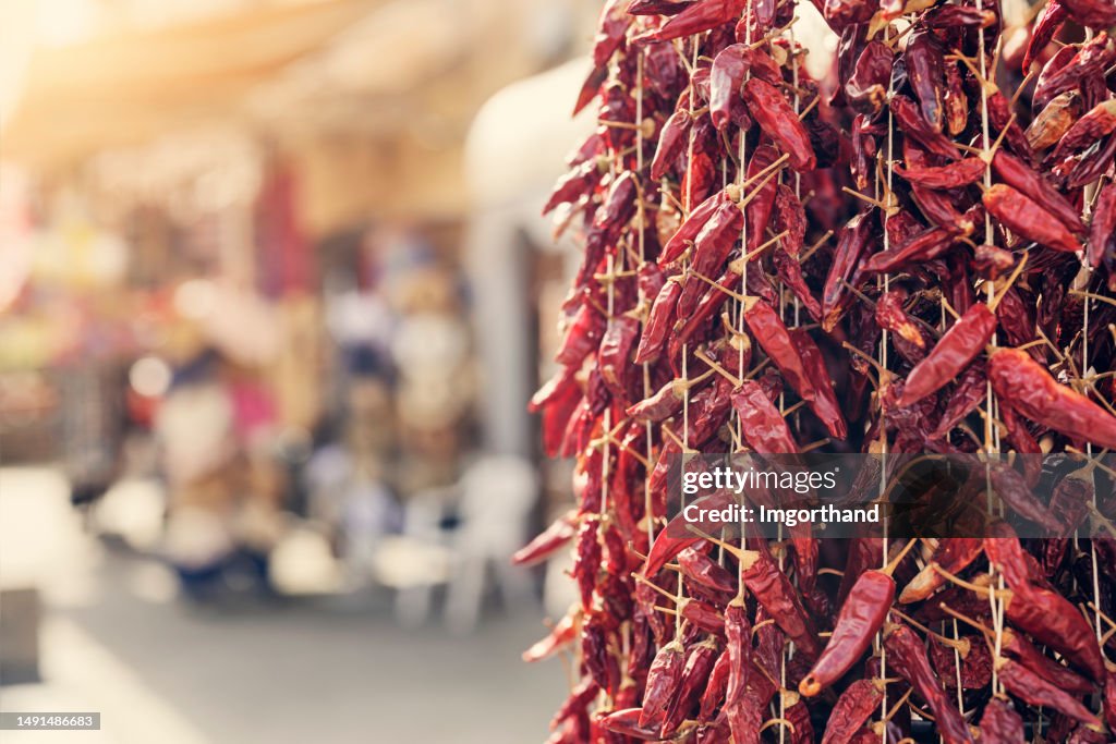 Dried Calabrian chili peppers hanging on street market