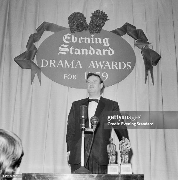 British playwright Wolf Mankowitz on stage to accept the best musical award for 'Make Me An Offer' at the Evening Standards Drama Awards for 1959 in...