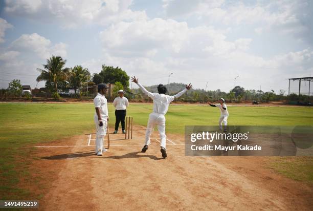 a bowler and the team appeals to umpire for the wicket during cricket match - dismissal cricket stock pictures, royalty-free photos & images