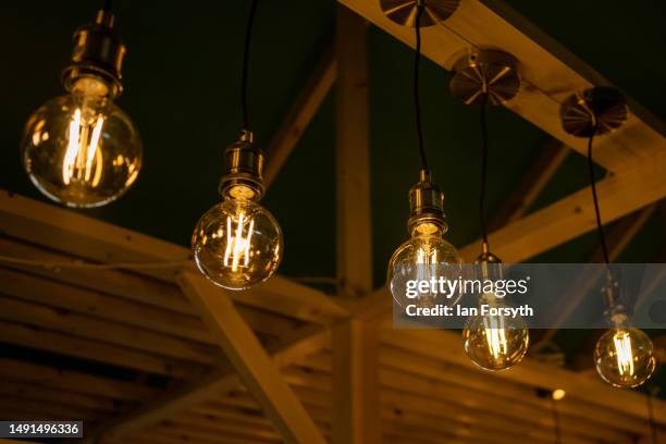 Energy efficient light bulbs shine on a display stand during the Fully Charged live show at the Yorkshire Events Centre on May 19, 2023 in Harrogate,...