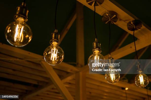 Energy efficient light bulbs shine on a display stand during the Fully Charged live show at the Yorkshire Events Centre on May 19, 2023 in Harrogate,...