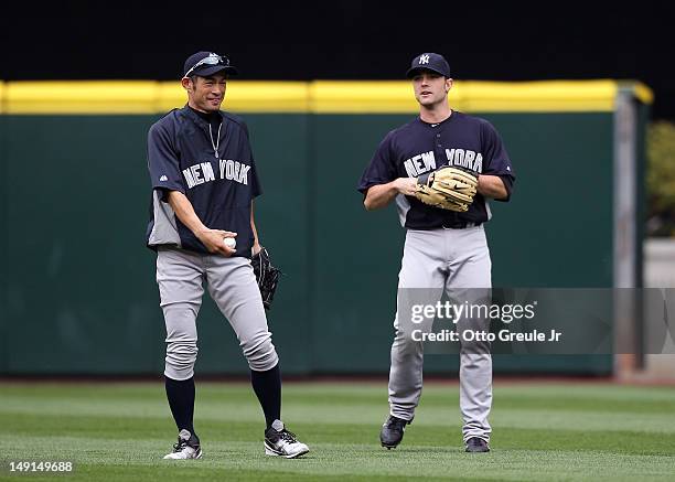 Ichiro Suzuki of the New York Yankees talks with David Robertson during batting practice after being traded to the Yankees from the Seattle Mariners...