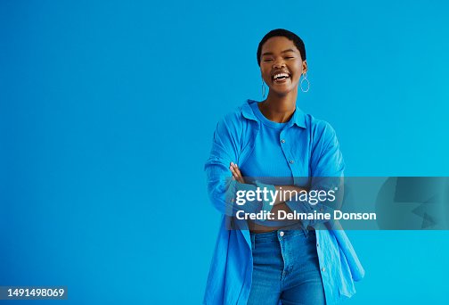 Young black woman standing with her arms crossed, laughing looking at the camera wearing casual clothing with copy space stock photo Young black woman standing with her arms crossed, laughing looking at the camera wearing casual clothing with copy space stock photo