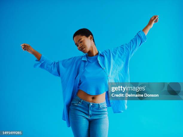 young black woman wearing casual clothing whilst dancing and smiling with copy space stock photo - swaying stock pictures, royalty-free photos & images