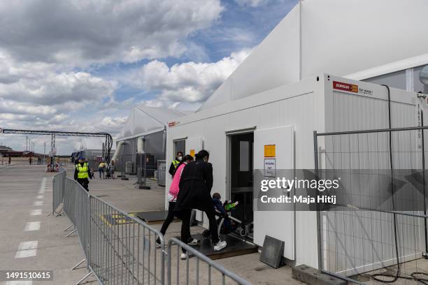 Refugees from Ukraine enter the temporary refugee shelter at former Tegel airport on May 19, 2023 in Berlin, Germany. Authorities are expecting...