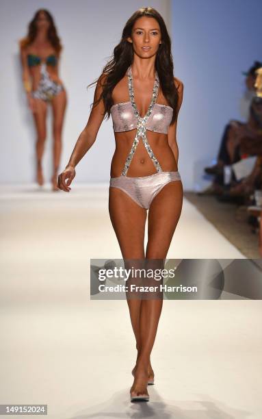 Model walks the runway at the Aguaclara show during Mercedes-Benz Fashion Week Swim 2013 at The Raleigh on July 23, 2012 in Miami, Florida.