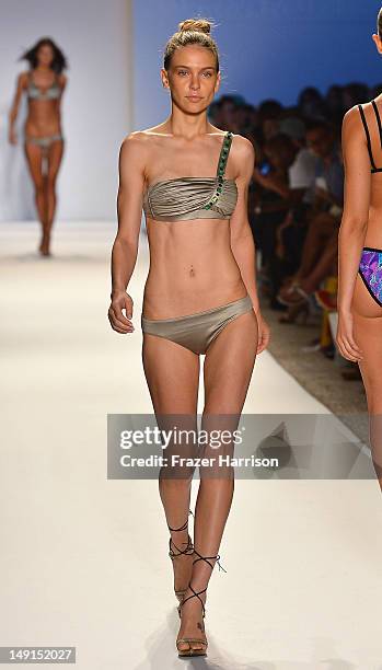 Model walks the runway at the Aguaclara show during Mercedes-Benz Fashion Week Swim 2013 at The Raleigh on July 23, 2012 in Miami, Florida.