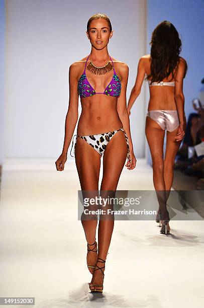 Model walks the runway at the Aguaclara show during Mercedes-Benz Fashion Week Swim 2013 at The Raleigh on July 23, 2012 in Miami, Florida.