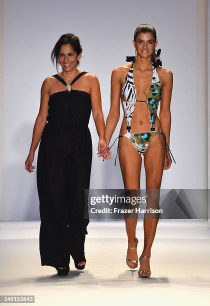 Designer Liliana Villalobos and a model walk the runway at the Aguaclara show during Mercedes-Benz Fashion Week Swim 2013 at The Raleigh on July 23,...