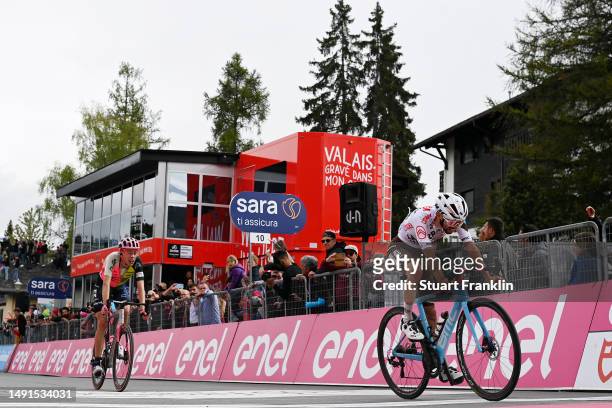 Hugh Carthy of The United Kingdom and Team EF Education-EasyPost and Valentin Paret-Peintre of France and AG2R Citroën Team cross the finish line...