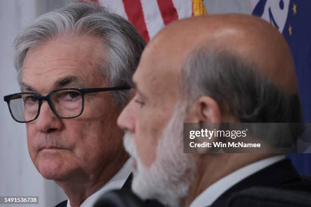 Federal Reserve Chairman Jerome Powell listens as former Chairman Ben Bernanke speaks at the Thomas Laubach Research Conference on “key issues in...