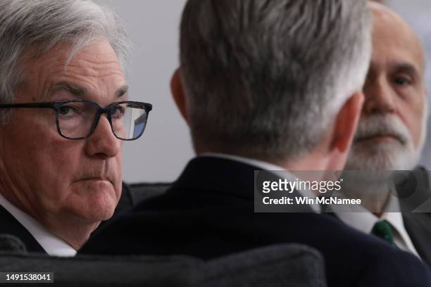 Federal Reserve Chairman Jerome Powell listens as former Chairman Ben Bernanke speaks at the Thomas Laubach Research Conference on “key issues in...