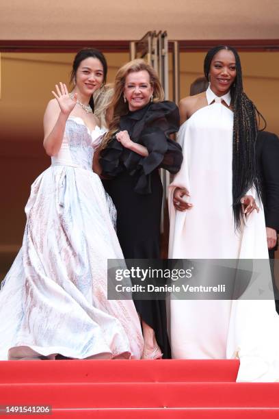 Tang Wei, Caroline Scheufele and Naomi Ackie attend the "The Zone Of Interest" red carpet during the 76th annual Cannes film festival at Palais des...