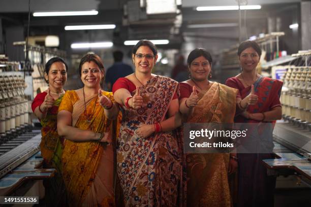 confident female coworkers standing together in factory - textile factory stock pictures, royalty-free photos & images