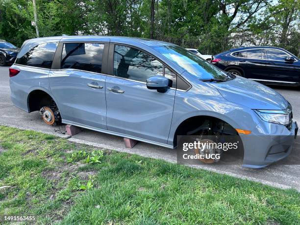 Car on blocks with Tires removed or stolen parked along Grand Central Service Road, Queens, New York.