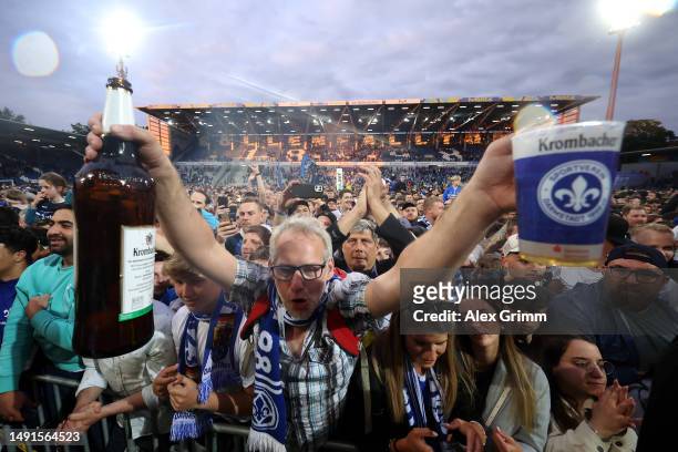 Fans of Darmstadt celebrate after the Second Bundesliga match between SV Darmstadt 98 and 1. FC Magdeburg at Merck-Stadion am Boellenfalltor on May...