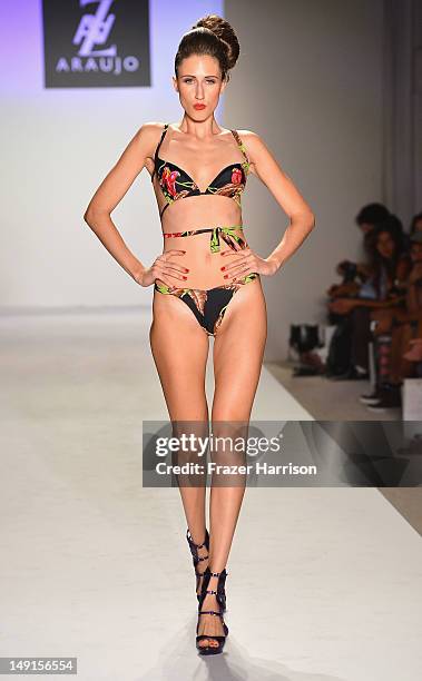 Model walks the runway at the A.Z Araujo show during Mercedes-Benz Fashion Week Swim 2013 show at The Raleigh on July 23, 2012 in Miami Beach,...