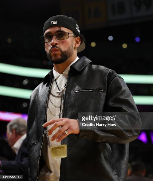 Rapper Bad Bunny walks courtside during the game between the Golden State Warriors and the Los Angeles Lakers in game six of the Western Conference...