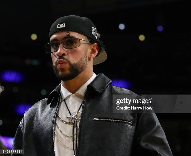 Rapper Bad Bunny walks courtside during the game between the Golden State Warriors and the Los Angeles Lakers in game six of the Western Conference...