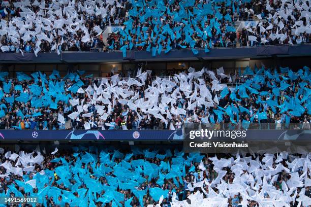 Manchester City fans waving flags before the UEFA Champions League semi-final second leg match between Manchester City FC and Real Madrid at Etihad...