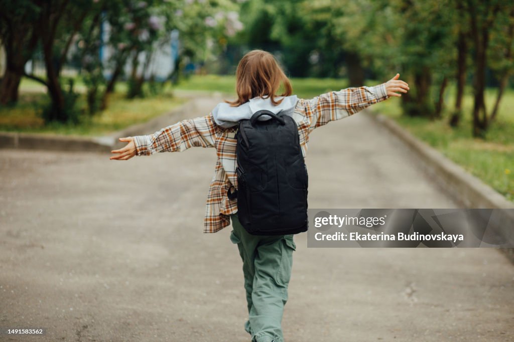 Girl holds a book in her hands on the street