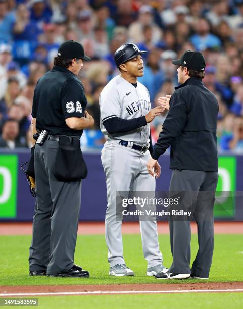 Third Base Coach Luis Rojas of the New York Yankees speaks to umpires during a game against the Toronto Blue Jays at Rogers Centre on May 16, 2023 in...